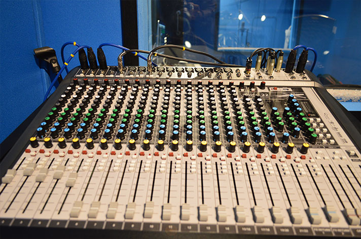 The faders and knobs of an analogue mixing console